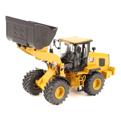 A yellow CAT toy model of a wheel loader with a black bucket, shown on a clean white background.