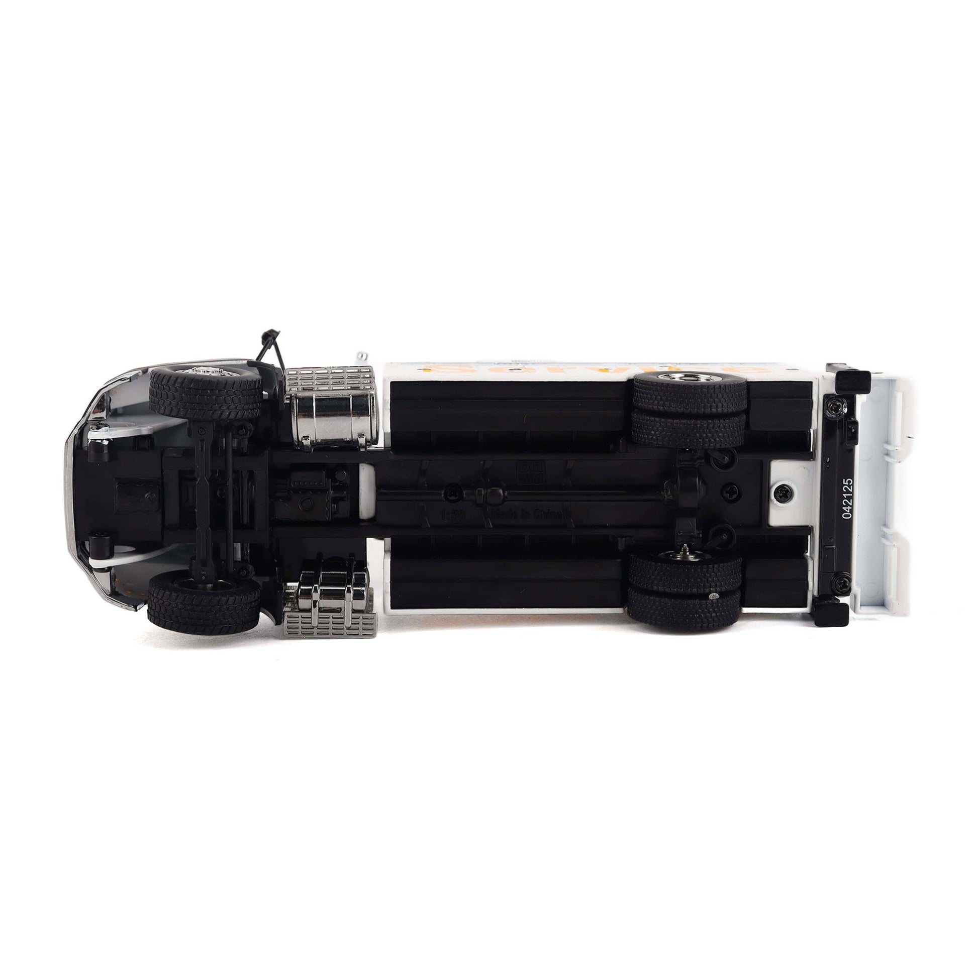 A miniature diecast model of a white and black service truck shown from underneath, revealing the detailed black chassis, wheels, and undercarriage, on a solid white background.