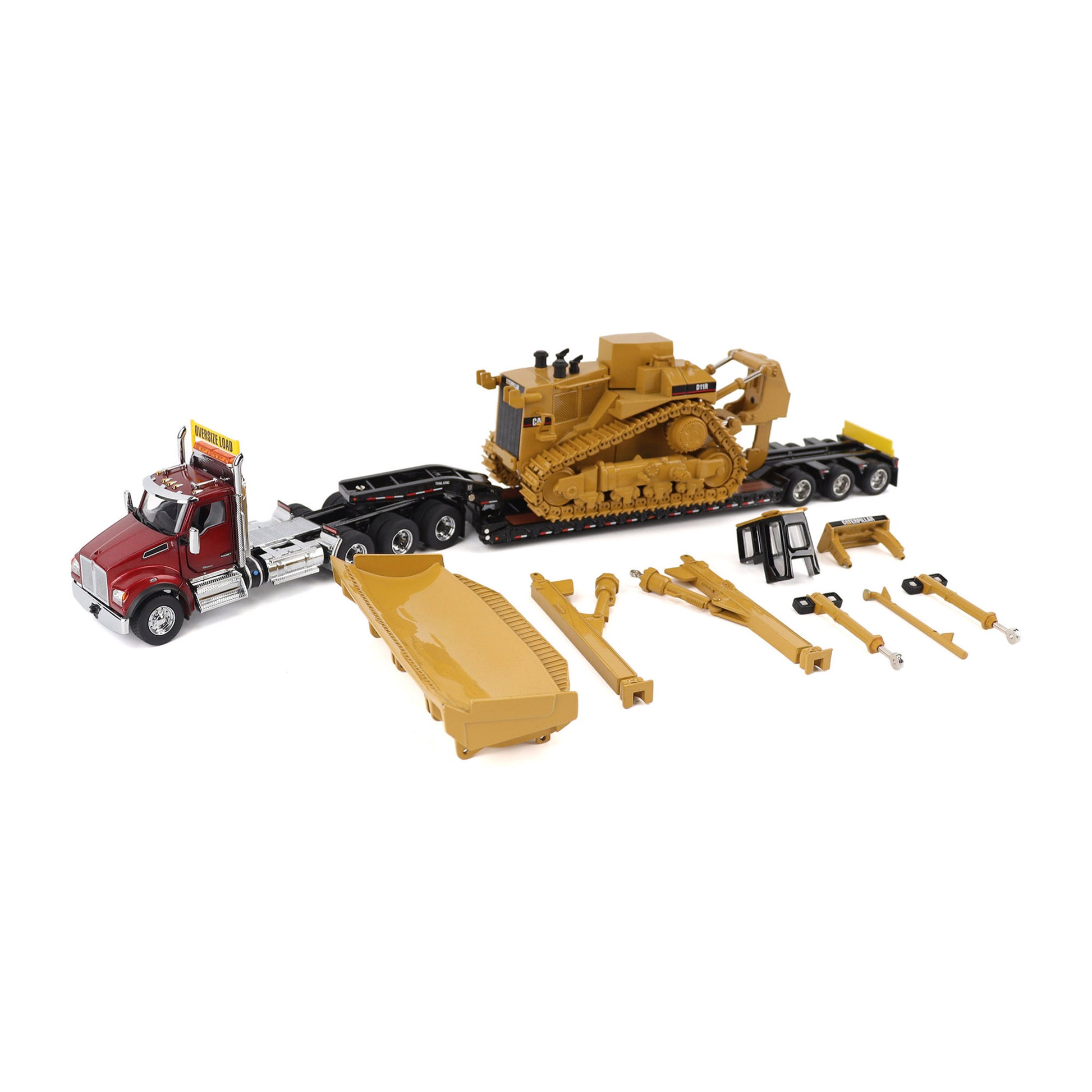 A toy construction set featuring a red Kenworth T880 semi-truck, a yellow Caterpillar D11R bulldozer on a black Trail King TK120 lowboy trailer, a large yellow blade, and several small yellow and black accessory pieces, all arranged on a white background.