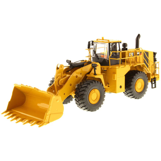 Model of a Yellow Caterpillar 988K Wheel Loader on a White Background