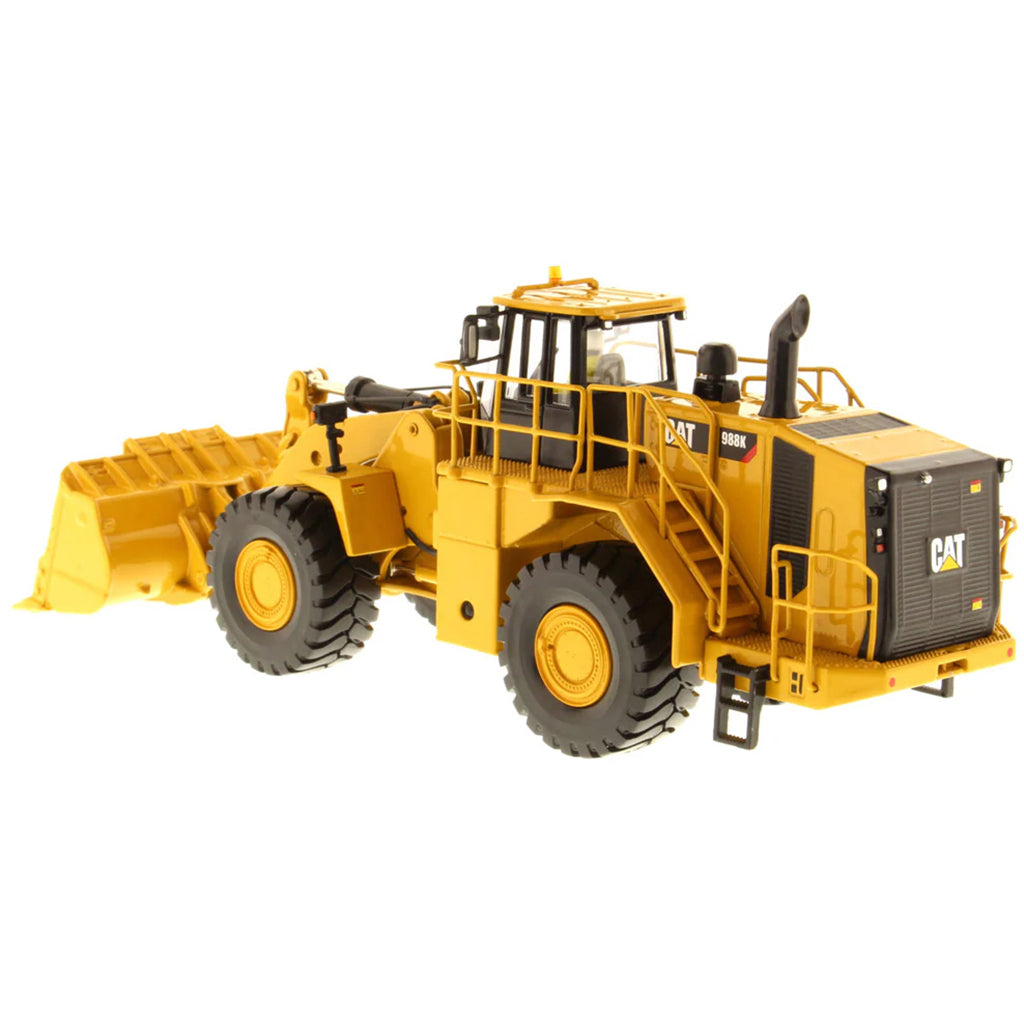 Model of a Yellow Caterpillar 988K Wheel Loader on a White Background