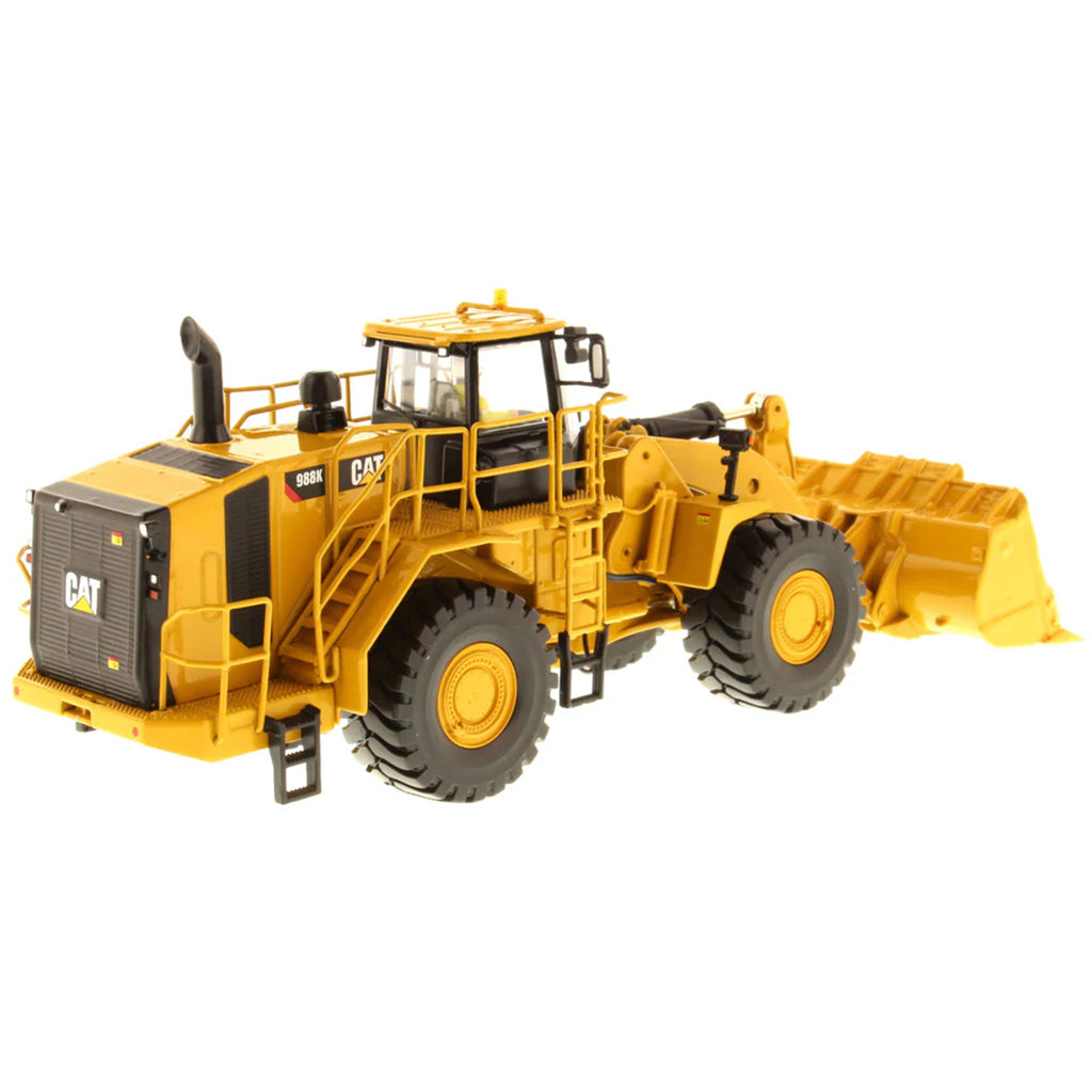 Model of a Yellow Caterpillar 988K Wheel Loader on a White Background