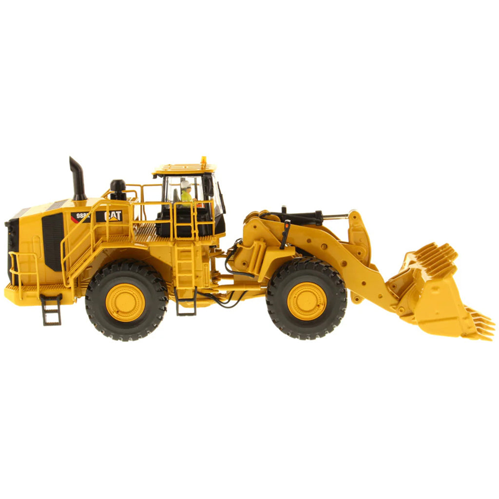 Model of a Yellow Caterpillar 988K Wheel Loader on a White Background
