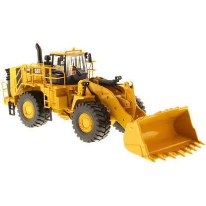 Model of a Yellow Caterpillar 988K Wheel Loader on a White Background