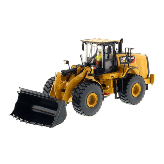 Model of a yellow Caterpillar 966M Wheel Loader on a white background