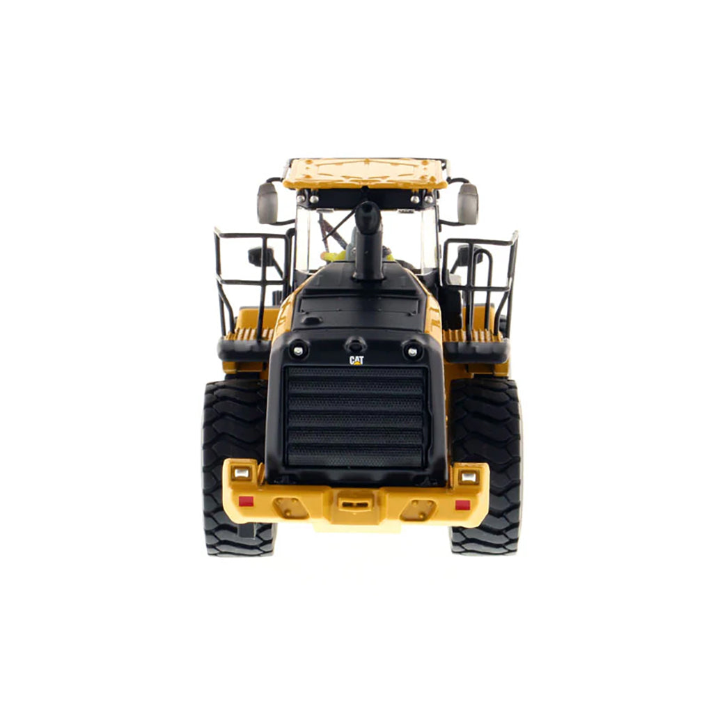 Model of a yellow Caterpillar 966M Wheel Loader on a white background