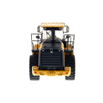 Model of a yellow Caterpillar 966M Wheel Loader on a white background