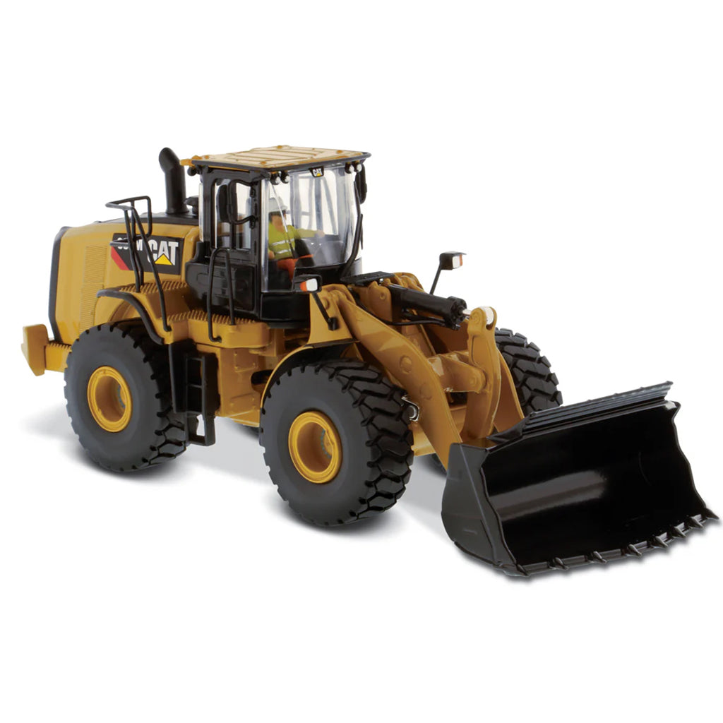 Model of a yellow Caterpillar 966M Wheel Loader on a white background