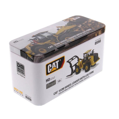 HO scale model of a CAT 972M wheel loader with log fork, presented in its original white and brown tin packaging by Diecast Masters.