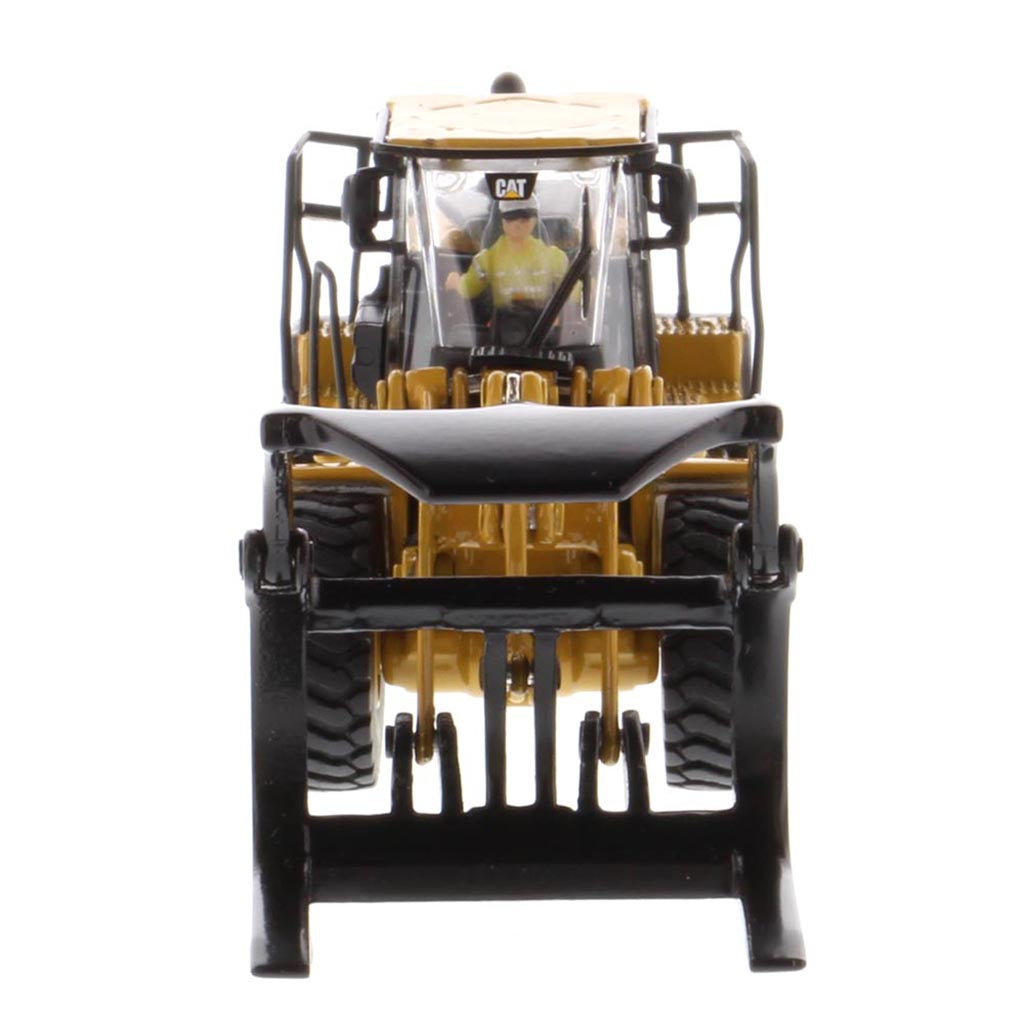 1:50th Scale Diecast Model of a Yellow and Black Caterpillar 972M Wheel Loader with Log Forks on a White Background