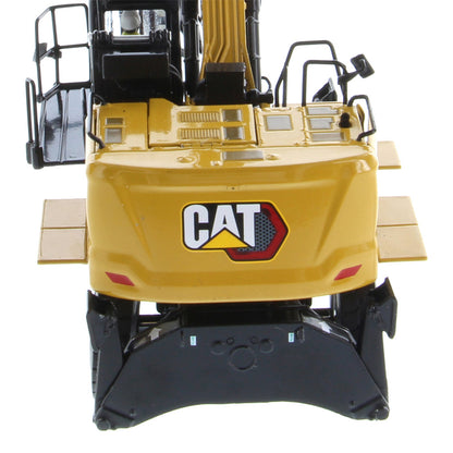 A yellow and black CAT excavator toy or model shown from the rear, featuring the CAT logo on the back and a white background.