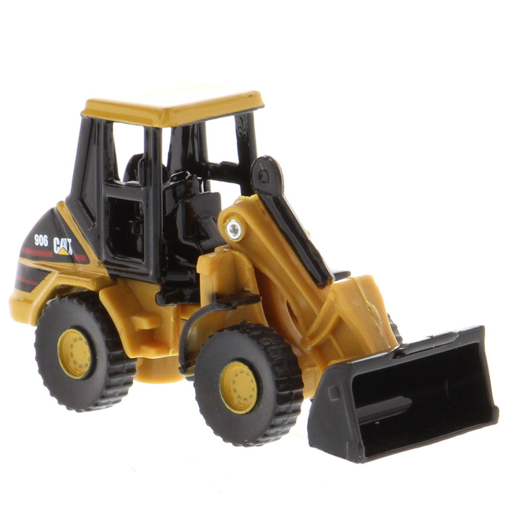 A miniature yellow and black CAT 990 toy loader with a front bucket attachment, shown on a plain white background.