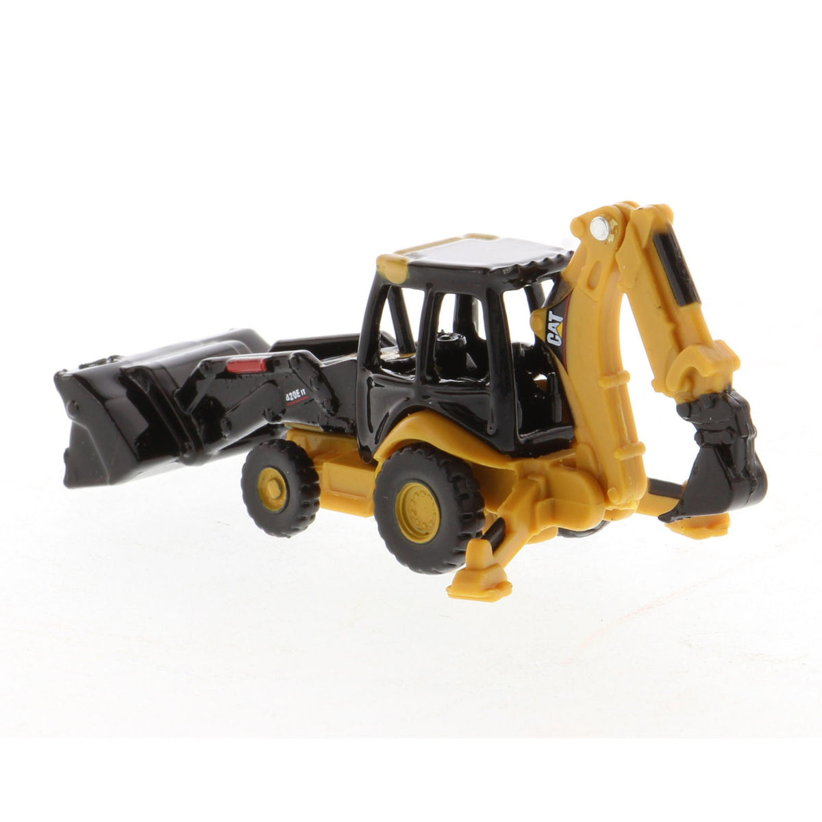 A small yellow and black toy caterpillar backhoe loader with a front loader bucket and rear excavating arm, photographed on a plain white background.