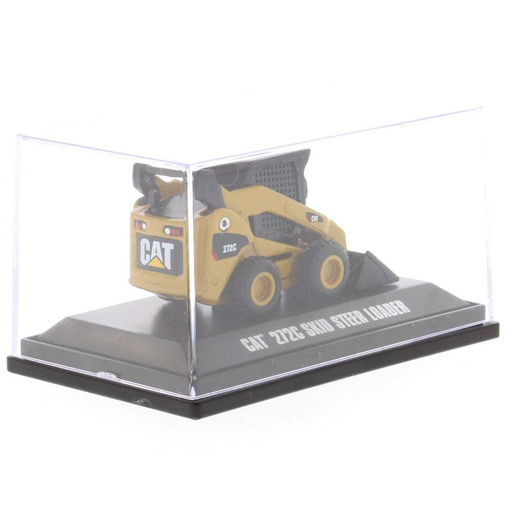 A miniature yellow and black CAT 272C skid steer loader model, displayed inside a clear plastic protective case on a black base with text reading 'CAT 272C SKID STEER LOADER'.