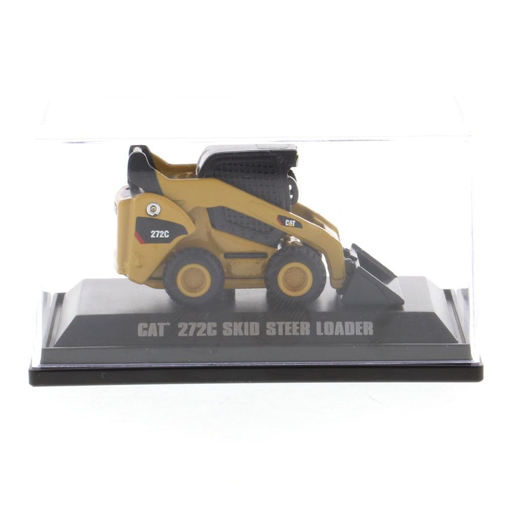 A miniature yellow and black CAT 272C skid steer loader model, displayed inside a clear plastic protective case on a black base with text reading 'CAT 272C SKID STEER LOADER'.