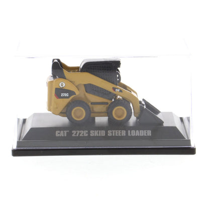 A miniature yellow and black CAT 272C skid steer loader model, displayed inside a clear plastic protective case on a black base with text reading 'CAT 272C SKID STEER LOADER'.