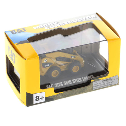 A miniature yellow and black CAT 272C skid steer loader model, displayed inside a clear plastic protective case on a black base with text reading 'CAT 272C SKID STEER LOADER'. in Yellow CAT Micro Construction Window Box Packaging