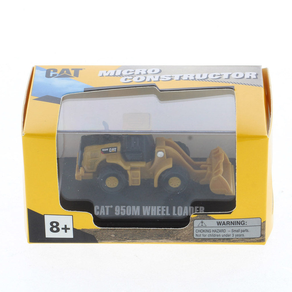 CAT Micro Constructor toy wheel loader in its original yellow and black retail packaging, featuring a clear plastic window and CAT branding.