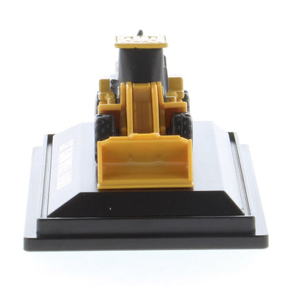 Mini Model of a Cat 950M Wheel Loader Mounted on a Black Display Base on a White background