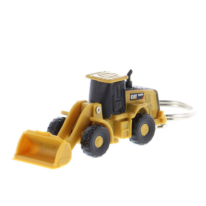 A miniature yellow and black toy wheel loader keychain with a metal key ring attached, shown on a plain white background.