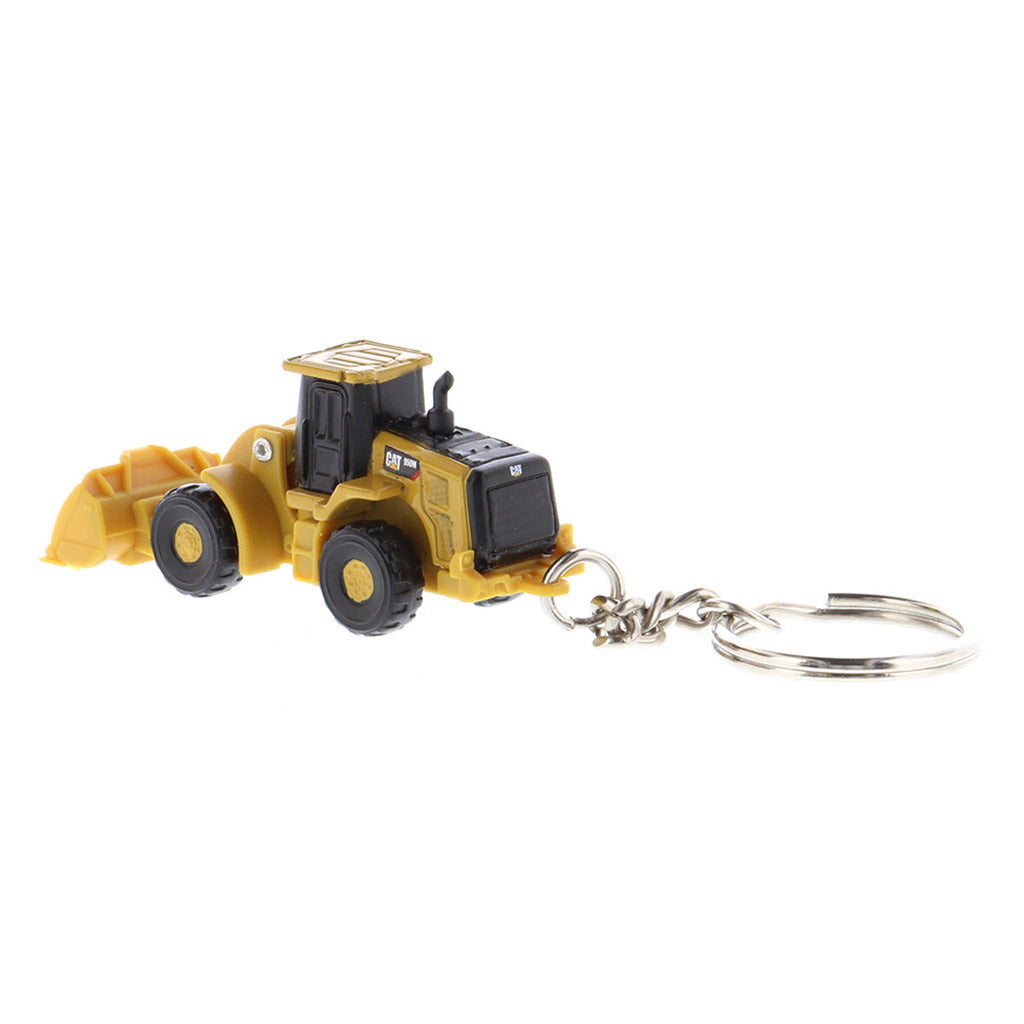 A miniature yellow and black toy wheel loader keychain with a metal key ring attached, shown on a plain white background.