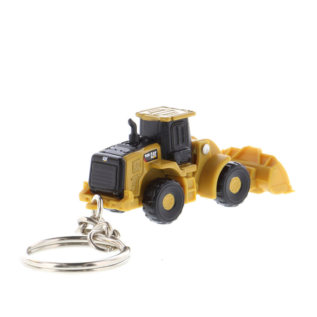 A miniature yellow and black toy wheel loader keychain with a metal key ring attached, shown on a plain white background.