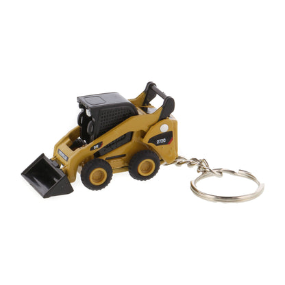 A miniature yellow and black toy skid steer keychain with a metal split ring, shown on a plain white background.