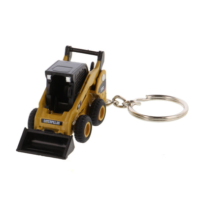 A miniature yellow and black toy skid steer keychain with a metal split ring, shown on a plain white background.