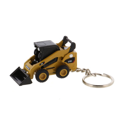 A miniature yellow and black toy skid steer keychain with a metal split ring, shown on a plain white background.