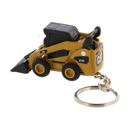 A miniature yellow and black toy skid steer keychain with a metal split ring, shown on a plain white background.