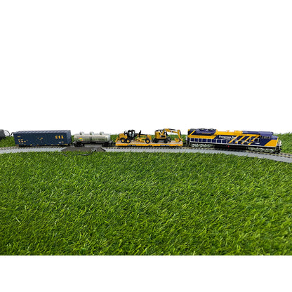 Model train set on a grassy field with a white background