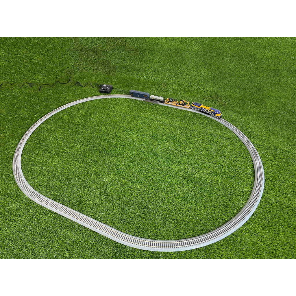 Model train set on a circular track with grass background