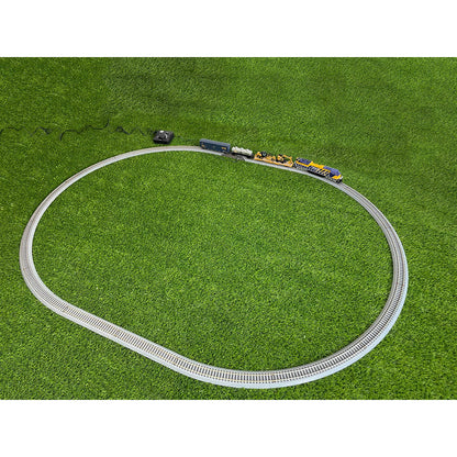 Model train set on a circular track with grass background