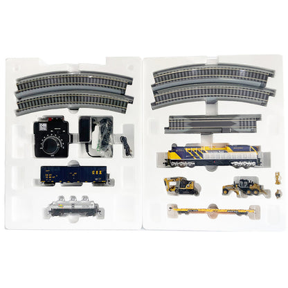 Model train set with tracks and cars in packaging on a white background