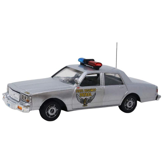 Model police car with a light bar on a white background
