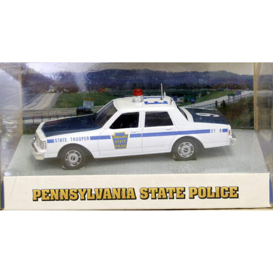Model of a Pennsylvania State Police car on a display box with a scenic background.