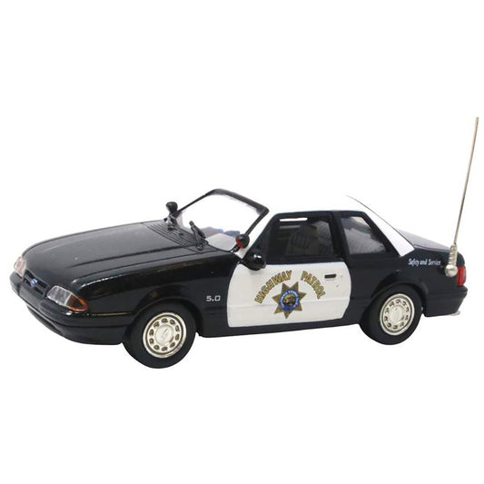 Model police car with a white and black color scheme on a white background