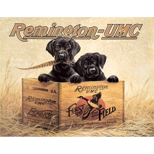 Two black puppies in a wooden crate with Remington-UMC branding on a beige background.