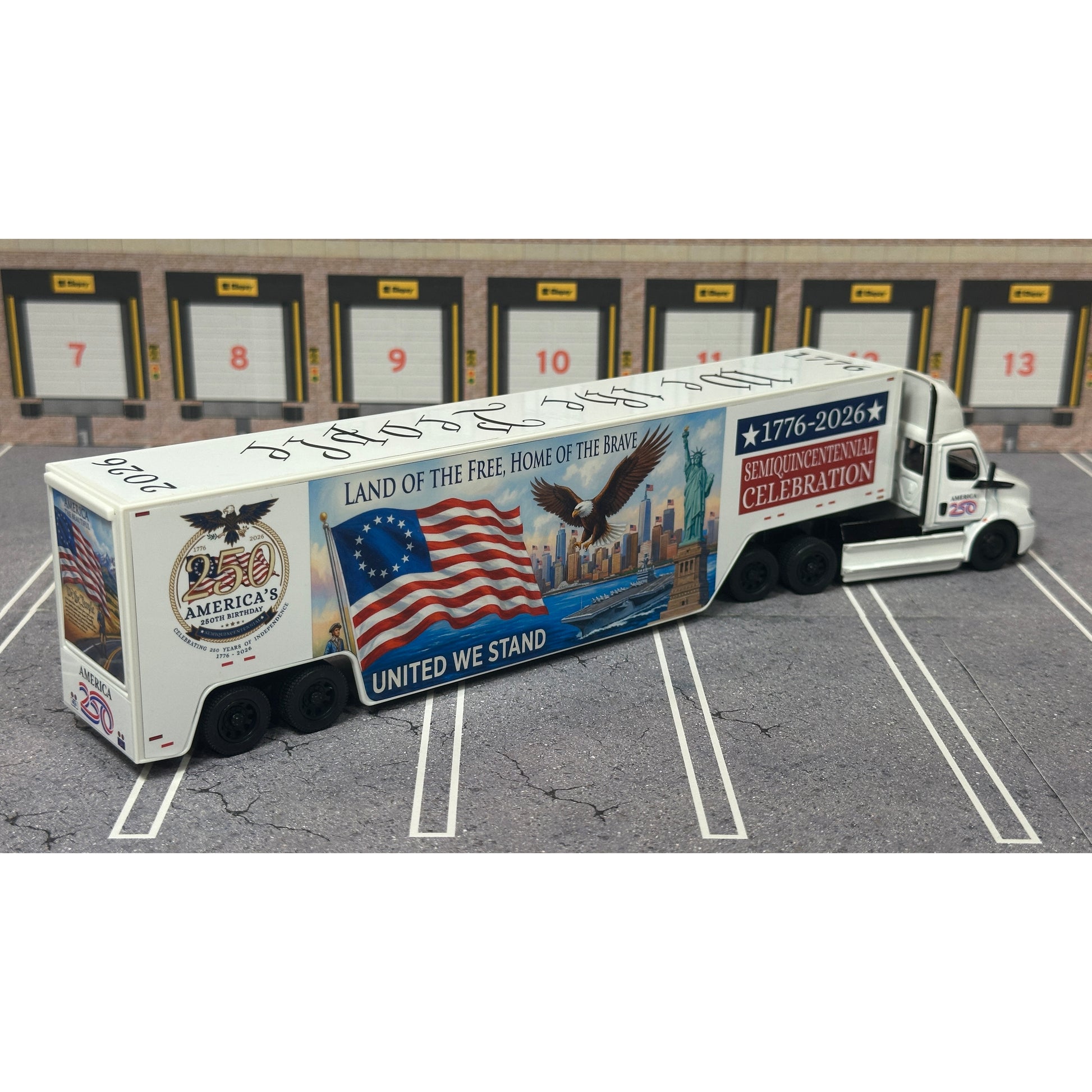 A diecast model of a Freightliner Cascadia semi-truck parked in a simulated parking lot. The trailer features a detailed historical design celebrating the United States' 250th anniversary with 'We the People' written on the top, alongside an American flag, eagle, and city skyline graphic with the text 'Land of the Free Home of the Brave' and 'United We Stand'.