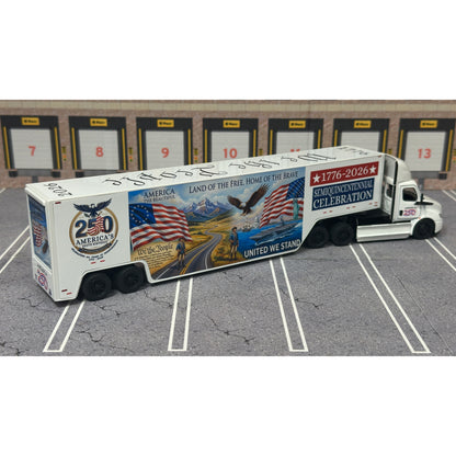 A diecast model of a Freightliner Cascadia semi-truck parked in a simulated parking lot. The trailer features a detailed historical design celebrating the United States' 250th anniversary with 'We the People' written on the top, alongside an American flag, eagle, and city skyline graphic with the text 'Land of the Free Home of the Brave' and 'United We Stand'.