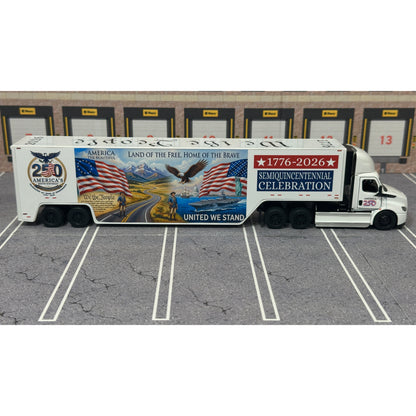 A diecast model of a Freightliner Cascadia semi-truck parked in a simulated parking lot. The trailer features a detailed historical design celebrating the United States' 250th anniversary with 'We the People' written on the top, alongside an American flag, eagle, and city skyline graphic with the text 'Land of the Free Home of the Brave' and 'United We Stand'.