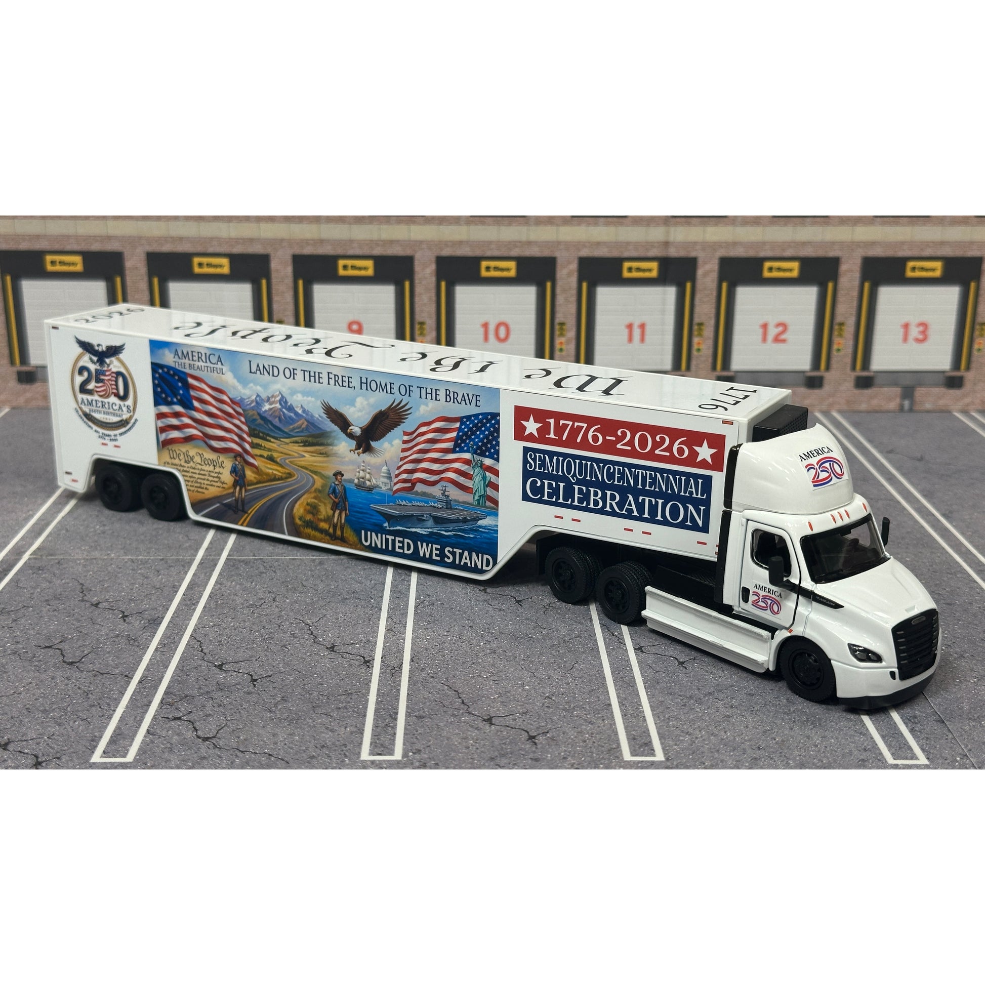 A diecast model of a Freightliner Cascadia semi-truck parked in a simulated parking lot. The trailer features a detailed historical design celebrating the United States' 250th anniversary with 'We the People' written on the top, alongside an American flag, eagle, and city skyline graphic with the text 'Land of the Free Home of the Brave' and 'United We Stand'.