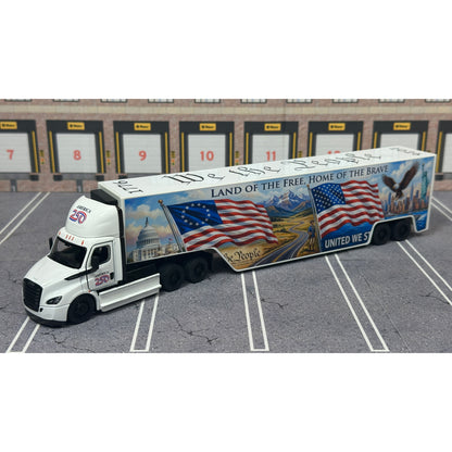 A diecast model of a Freightliner Cascadia semi-truck parked in a simulated parking lot. The trailer features a detailed historical design celebrating the United States' 250th anniversary with 'We the People' written on the top, alongside an American flag, eagle, and city skyline graphic with the text 'Land of the Free Home of the Brave' and 'United We Stand'.