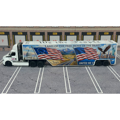 A diecast model of a Freightliner Cascadia semi-truck parked in a simulated parking lot. The trailer features a detailed historical design celebrating the United States' 250th anniversary with 'We the People' written on the top, alongside an American flag, eagle, and city skyline graphic with the text 'Land of the Free Home of the Brave' and 'United We Stand'.
