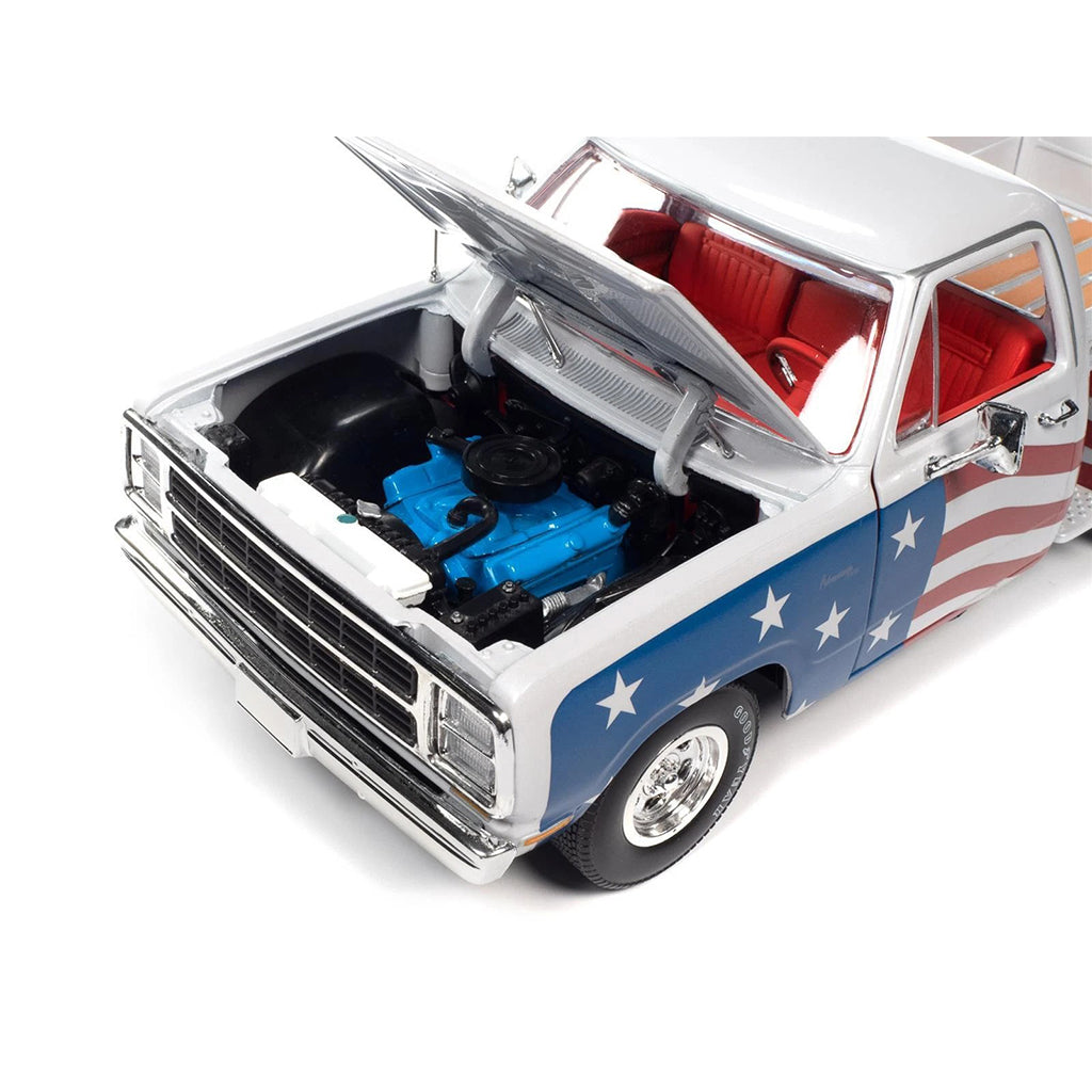 Model truck with American flag design and open hood showing engine