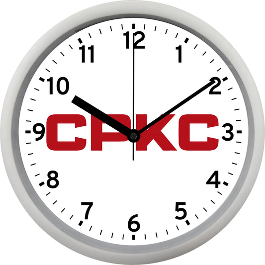 Wall clock with 'CPKC' logo on a white background
