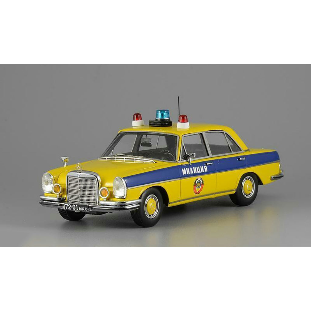 A 1975 Mercedes-Benz W108 'Moscow Police' model car in yellow, blue, and white colors with black wheels and interior.