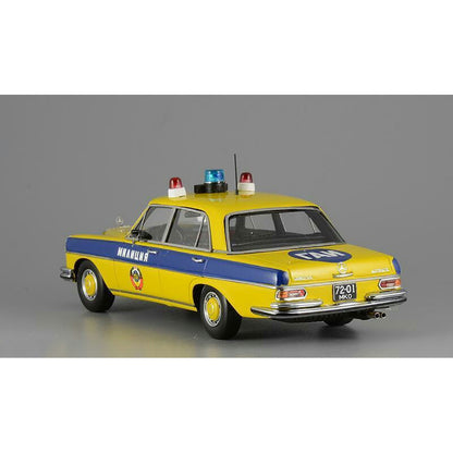 A 1975 Mercedes-Benz W108 'Moscow Police' model car in yellow, blue, and white colors with black wheels and interior.