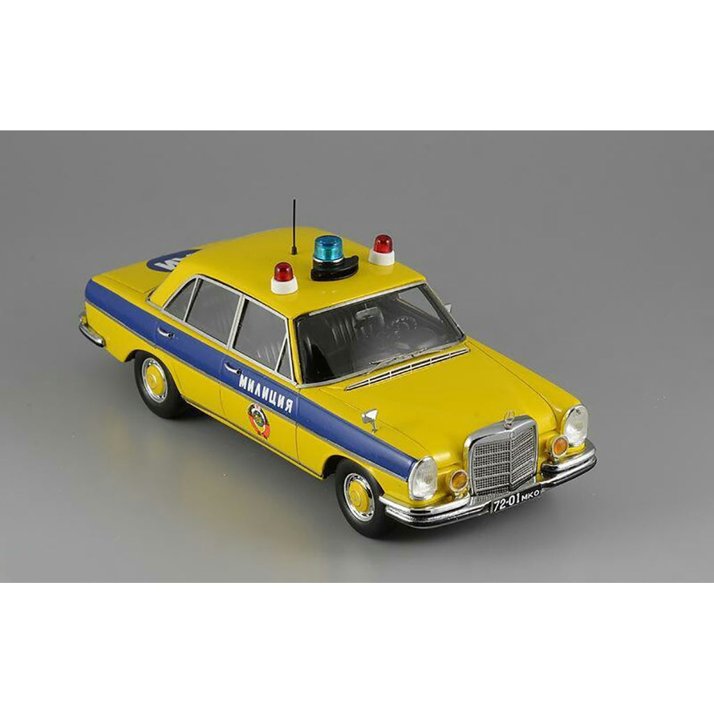 A 1975 Mercedes-Benz W108 'Moscow Police' model car in yellow, blue, and white colors with black wheels and interior.