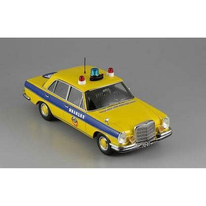 A 1975 Mercedes-Benz W108 'Moscow Police' model car in yellow, blue, and white colors with black wheels and interior.